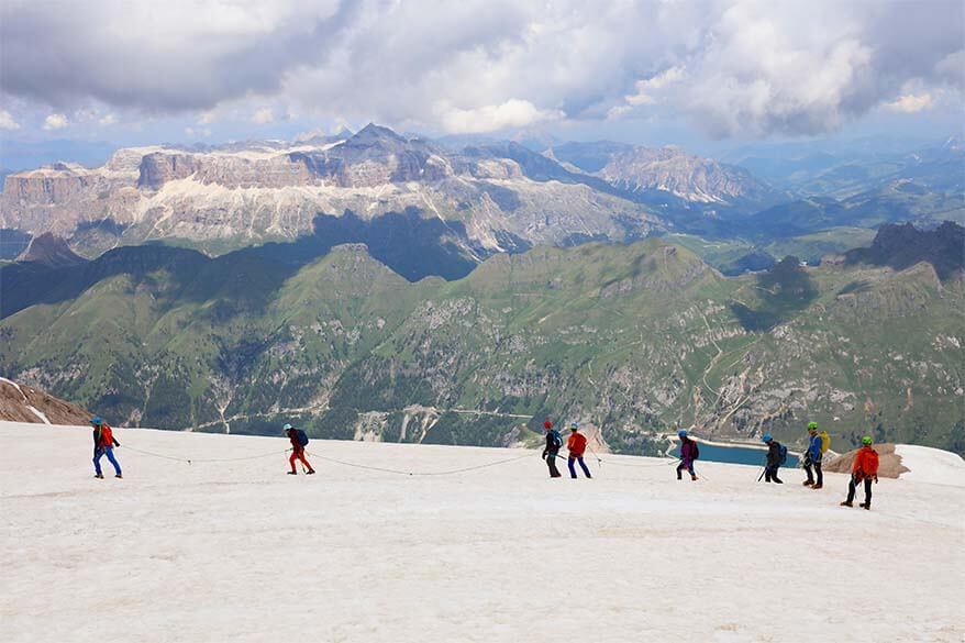 People hiking on a glacier at Marmolada in Italy