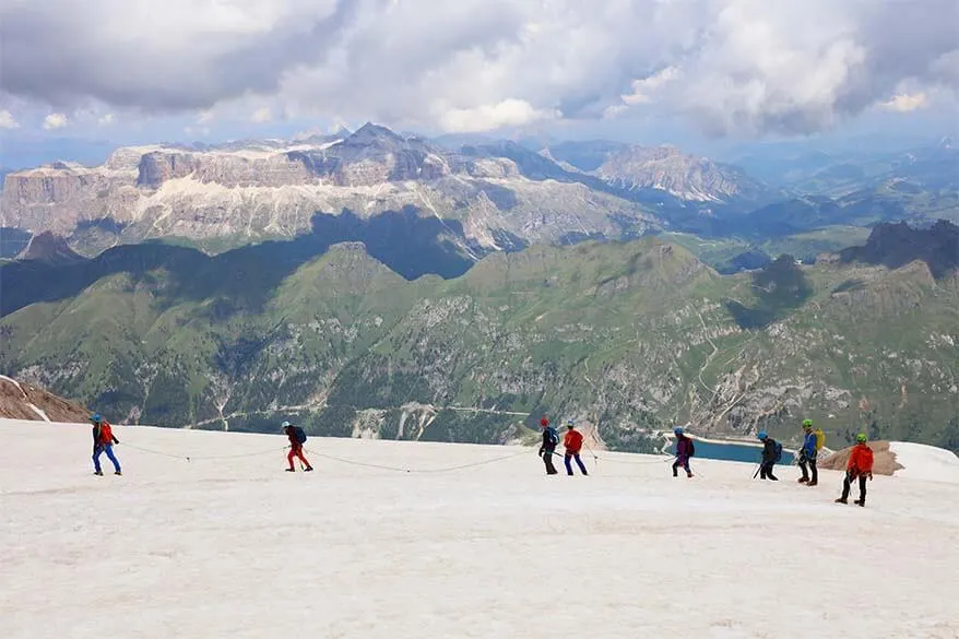 People hiking on a glacier at Marmolada in Italy