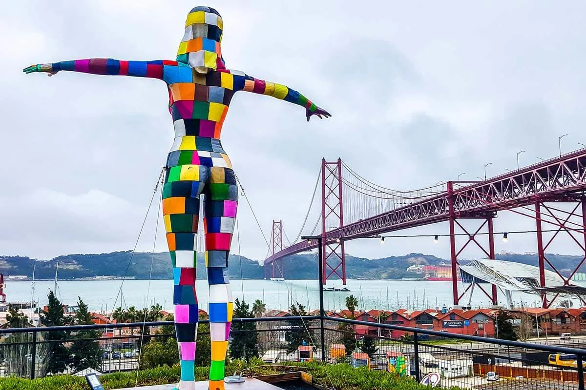 Colorful statue at LX Factory overlooking the 25th April Bridge in Lisbon