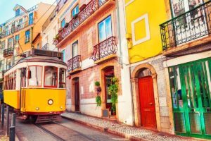 Yellow tram and colorful buildings in Lisbon Portugal