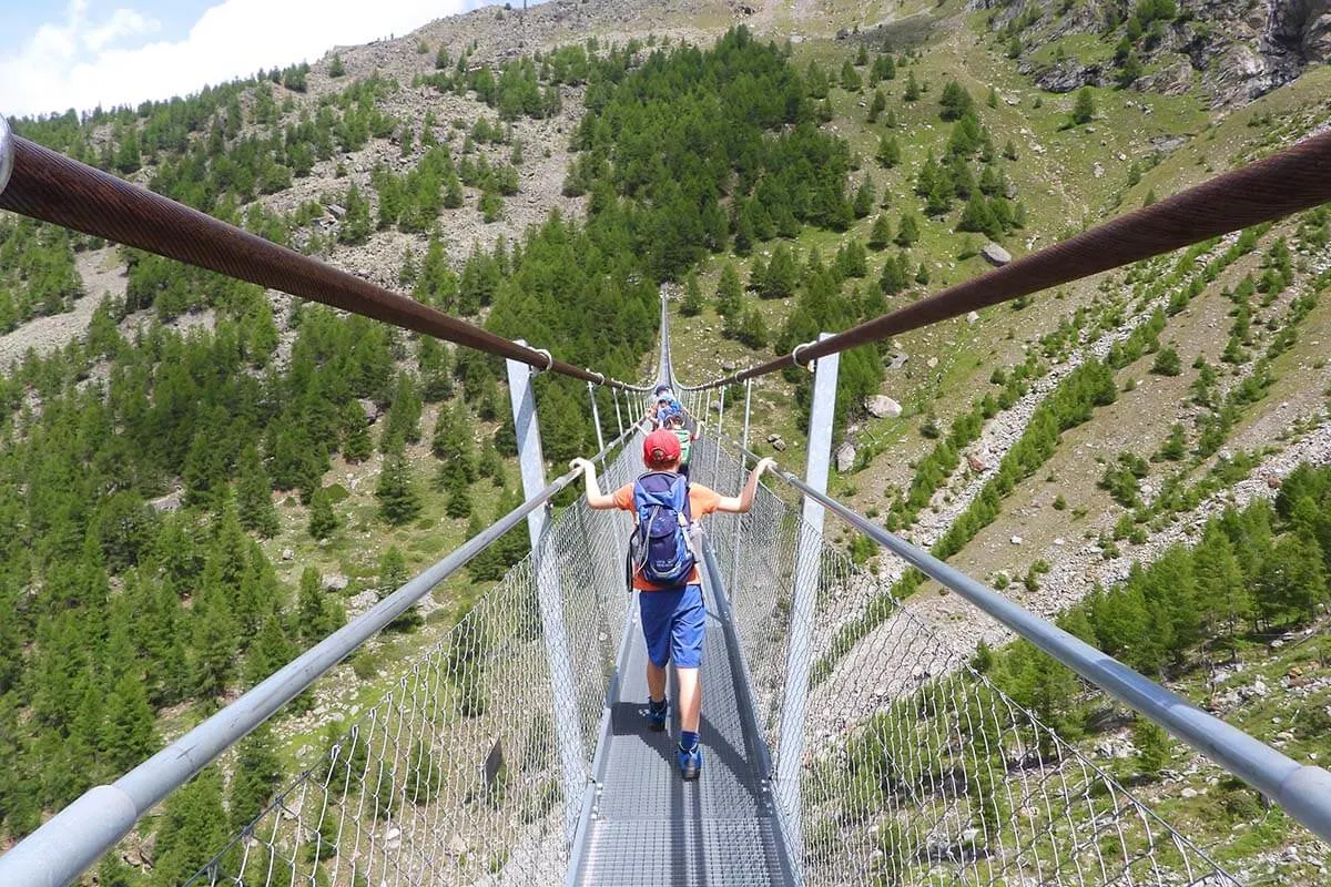 Kids crossing Charles Kuonen Suspension Bridge in Switzerland