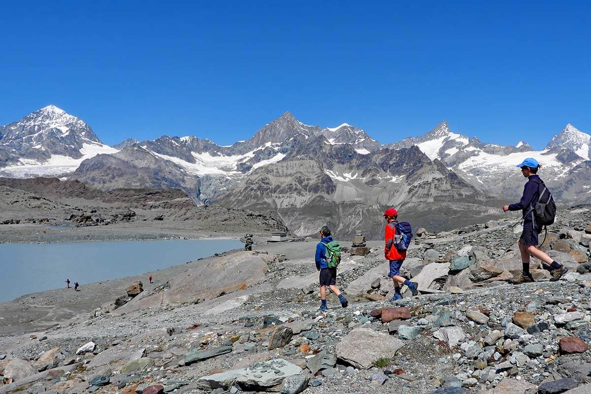 Kids hiking at Trockener Steg, trailhead of the Matterhorn Glacier Trail in Switzerland