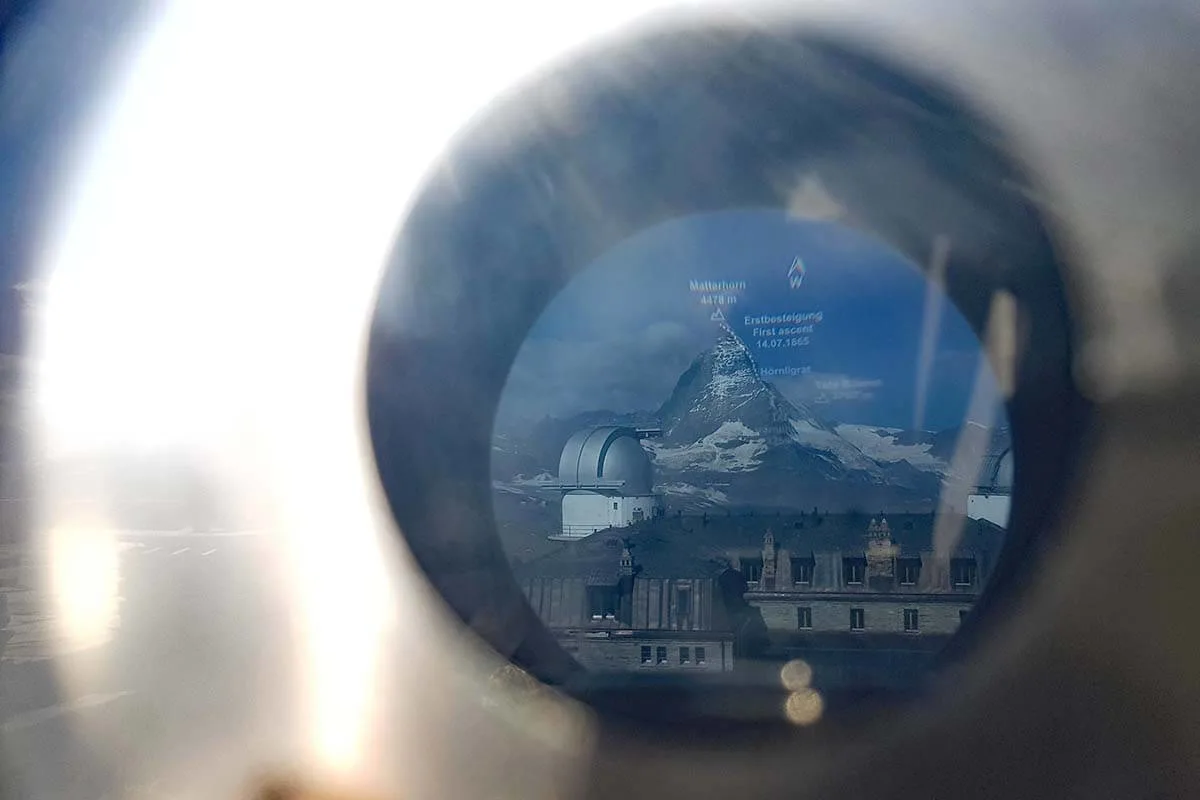 View of the Matterhorn and Gornergrat hotel via binoculars at the viewing platform in Gornergrat