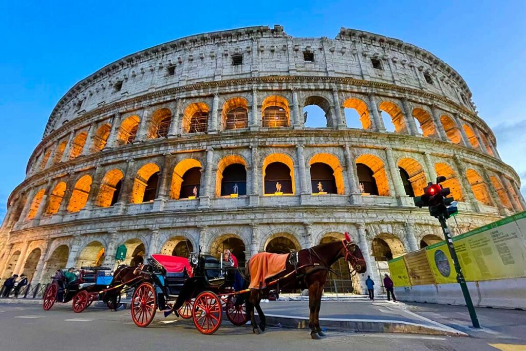 Horse carriages at Colosseum at twilight