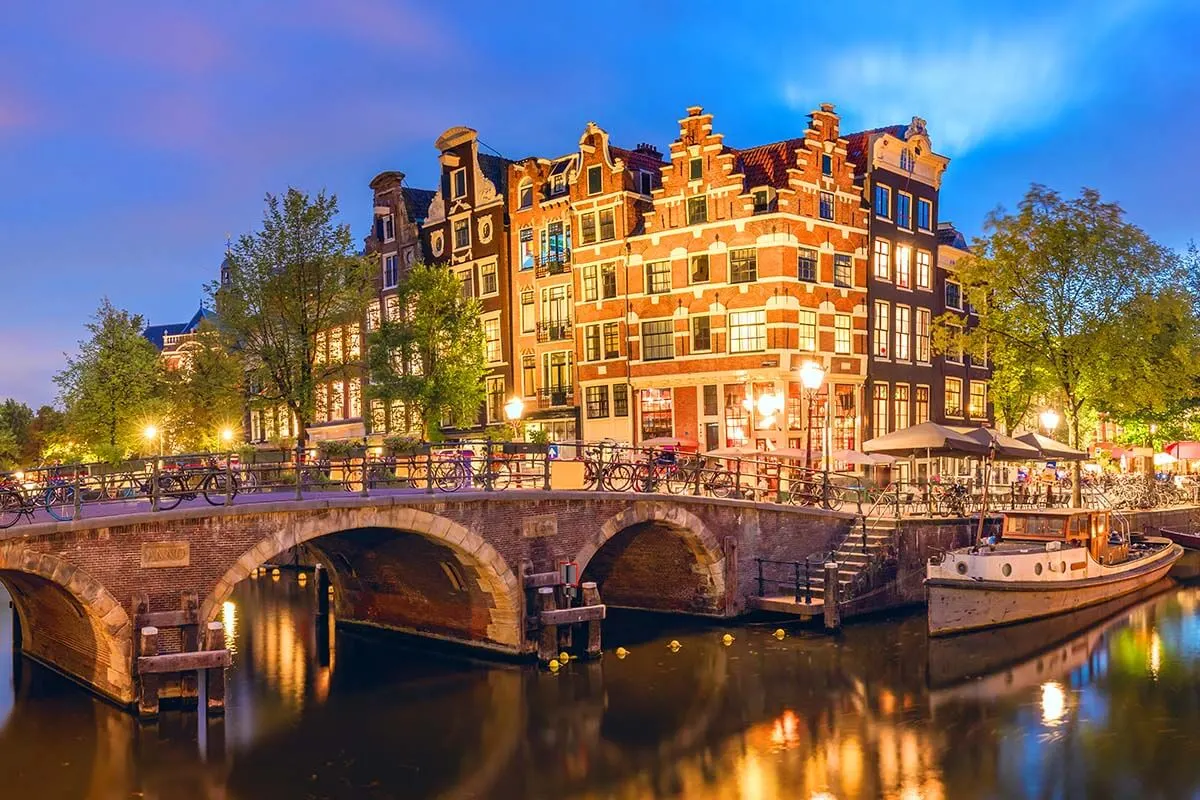 Amsterdam bridges and canals lit at night