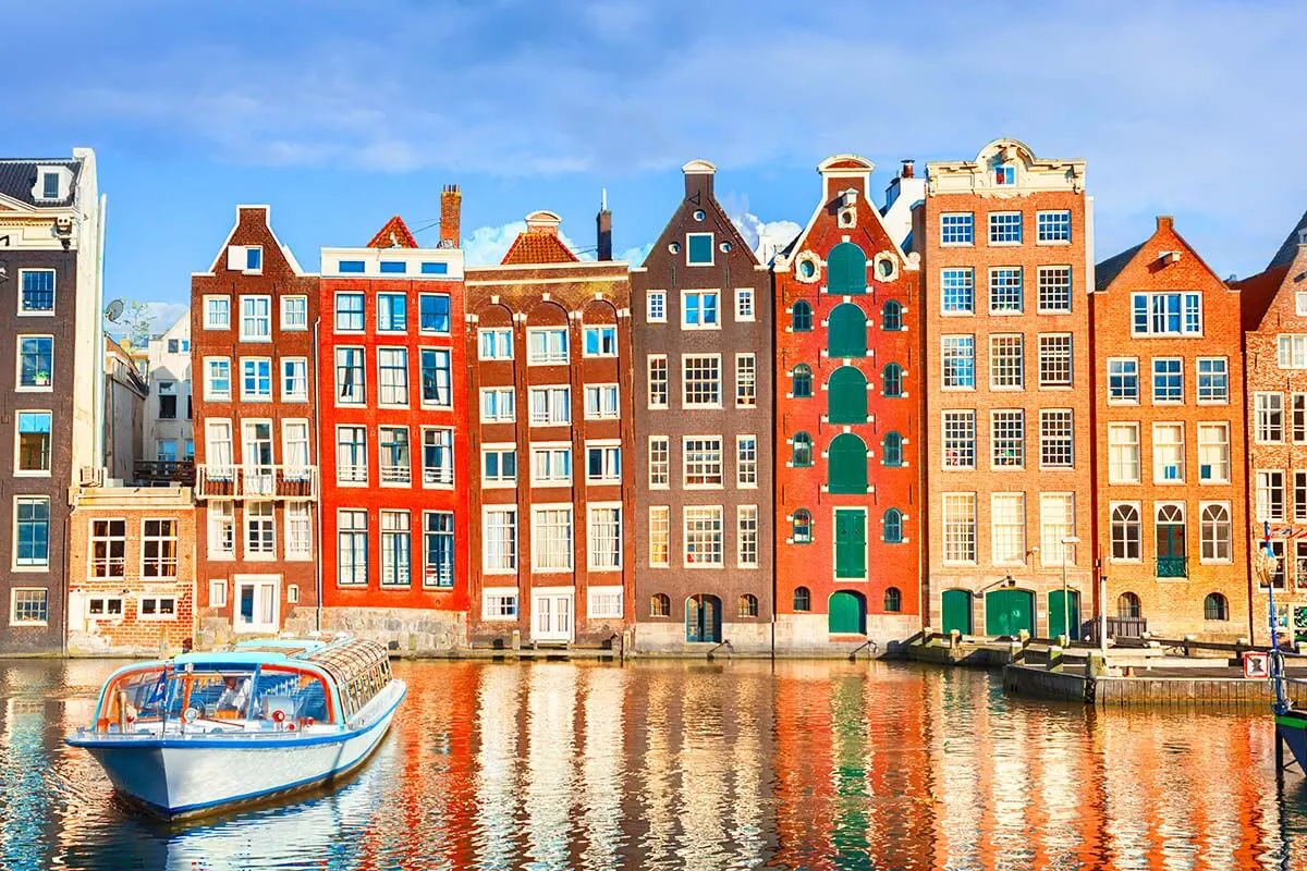 Colorful houses at Damrak waterfront in Amsterdam