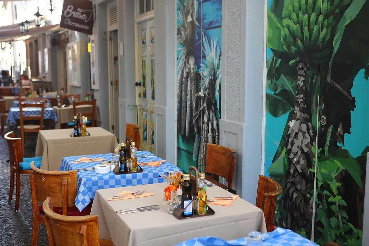 Restaurant tables on a street in Funchal old town Madeira