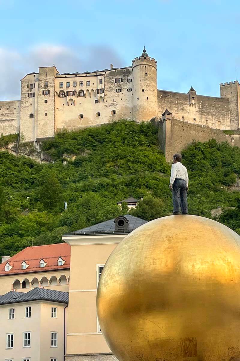 Hohensalzburg Fortress and Golden Sphere on Kapitelplatz in Salzburg Austria