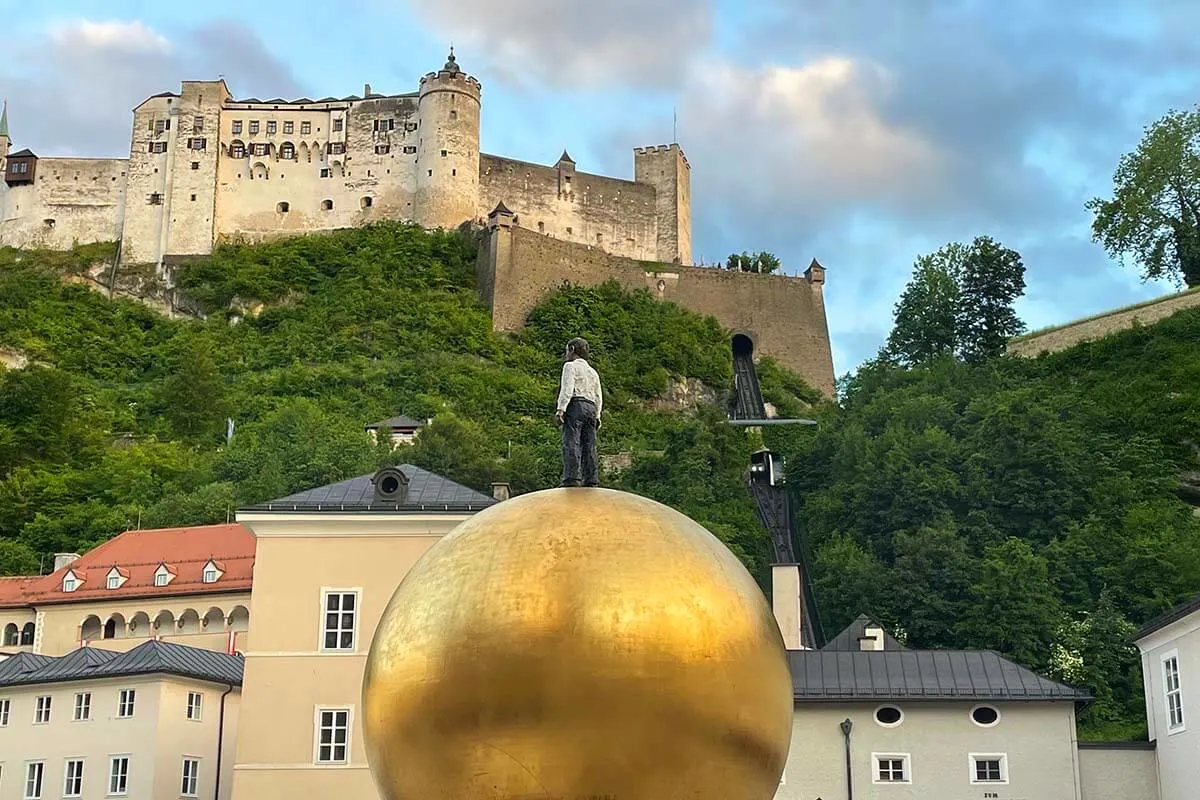 Salzburg Kapitelplatz golden sphere with a view of Fortress Hohensalzburg