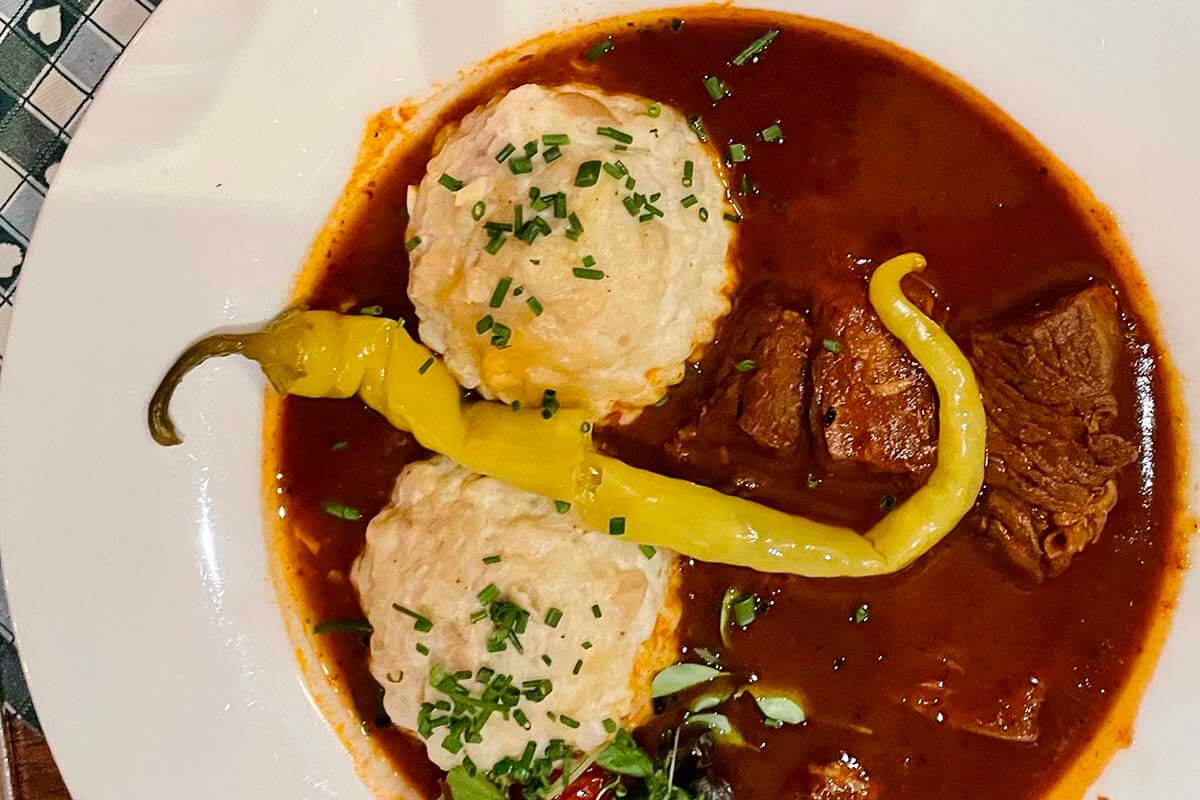 Traditional Austrian beef goulash with dumplings (rindergulasch semmelknödel)