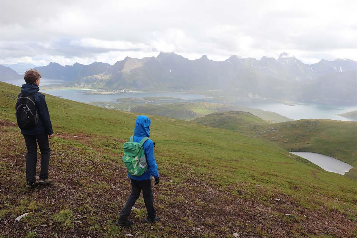 Kids hiking in Lofoten on a cold rainy day in July
