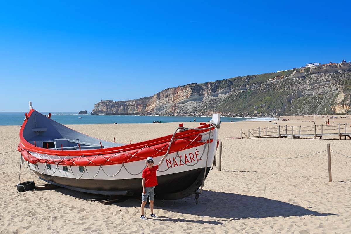 A big wooden boat on a beach in Nazare, Portugal