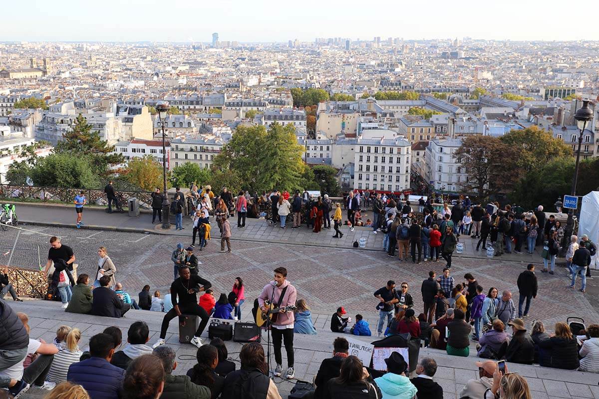 Gente en las escaleras de Montmartre frente a la Basílica del Sacre Coeur