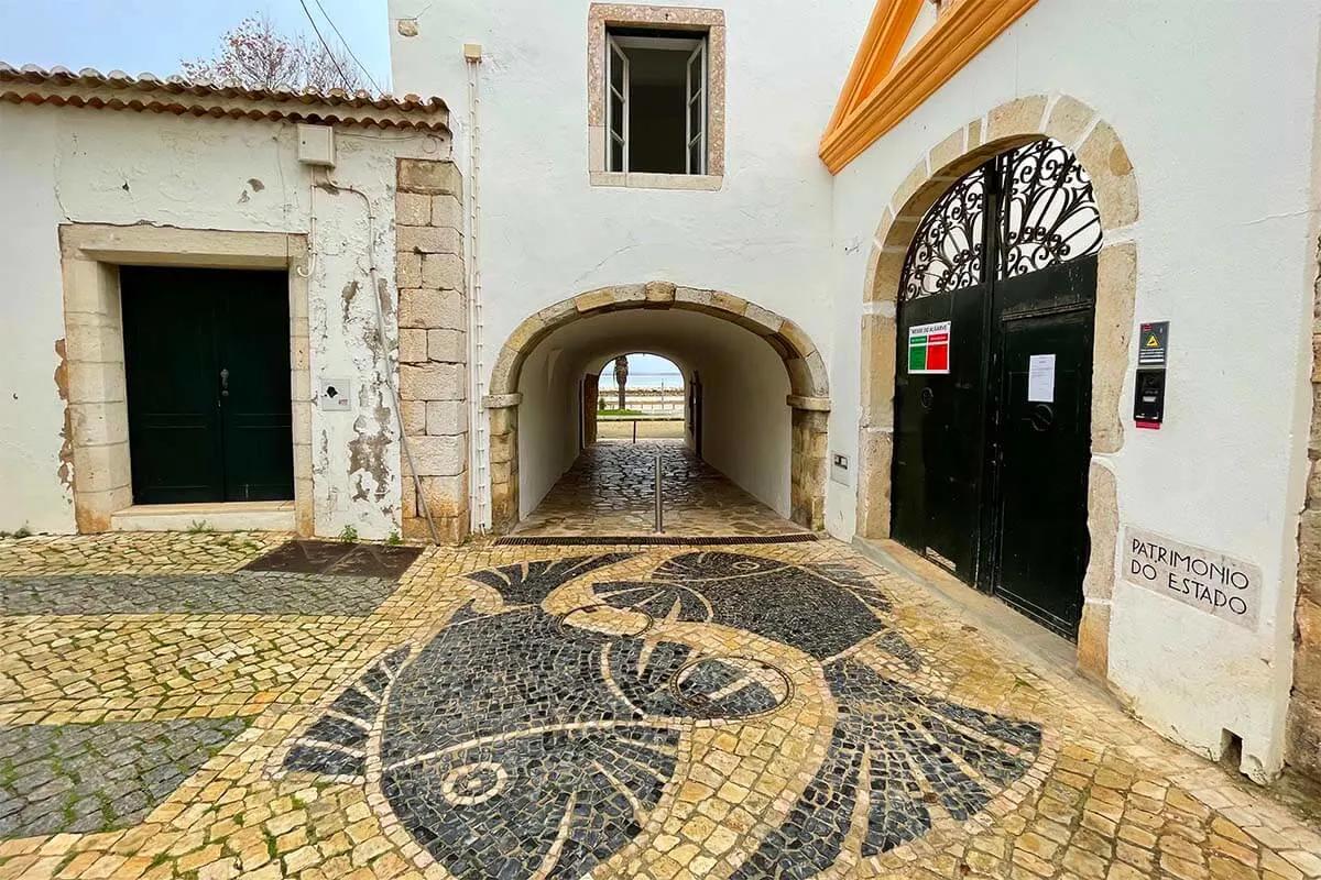 Beautiful pavement tiles and old city walls in Lagos town in Algarve Portugal
