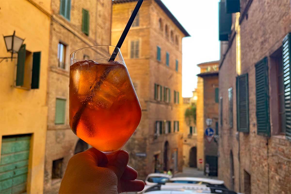 Glass of Spritz at a cafe in Siena old town, Italy