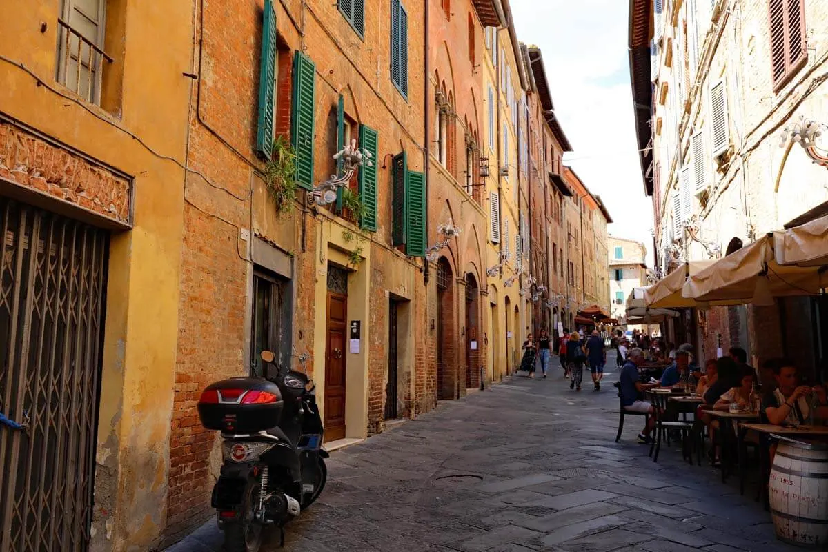 Via Camollia street in the old town of Siena, Italy