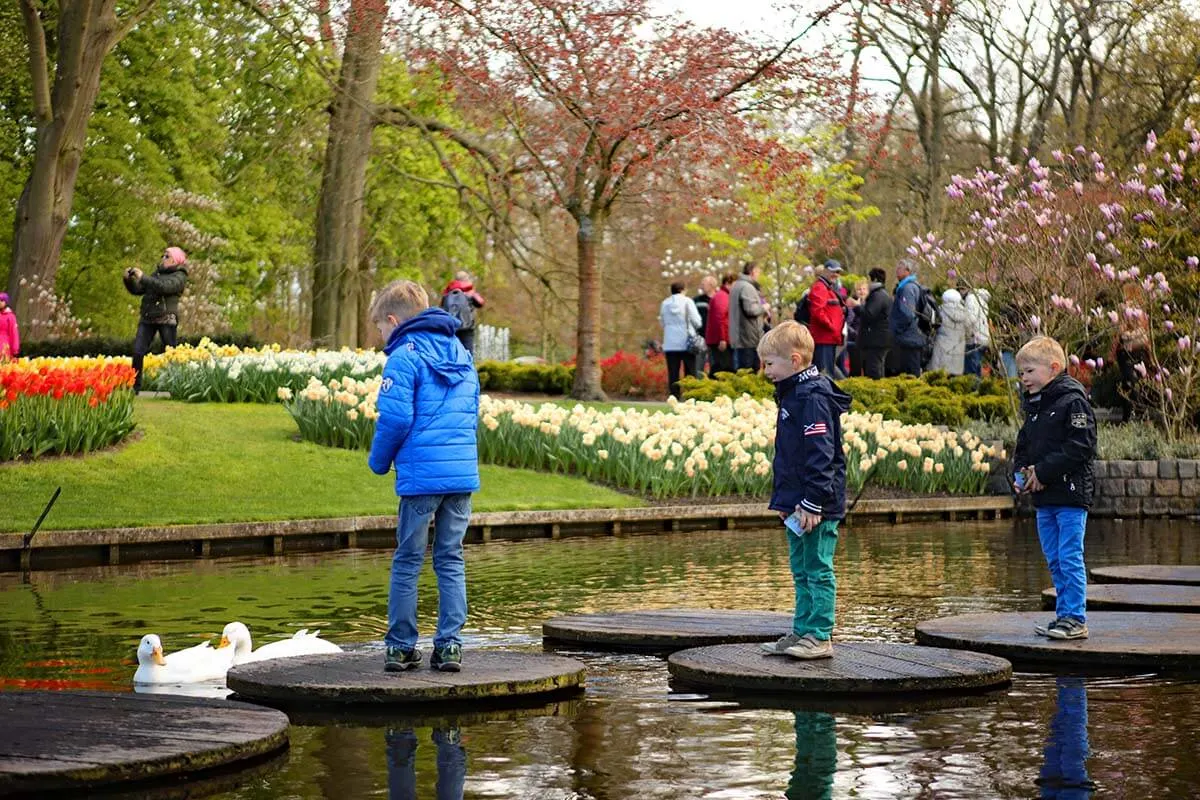 Kids walking over a pond in Keukenhof park in the Netherlands