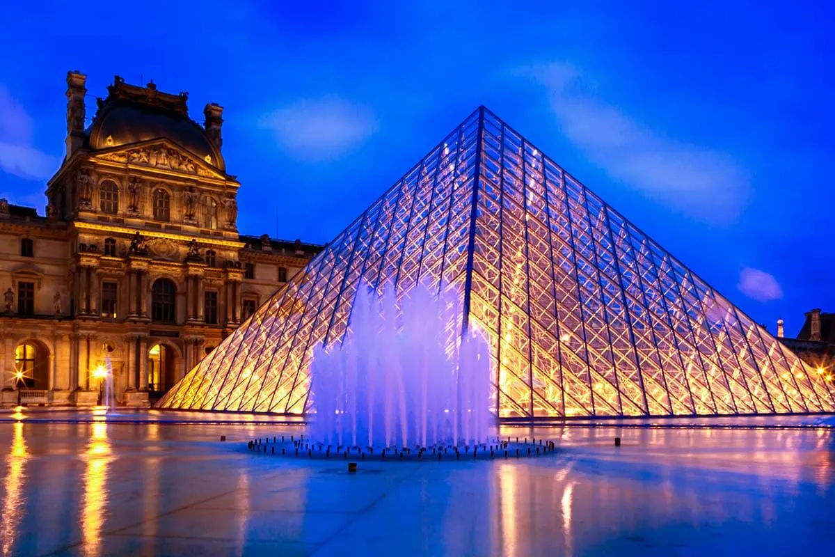 Louvre Pyramid and fountain lit at night