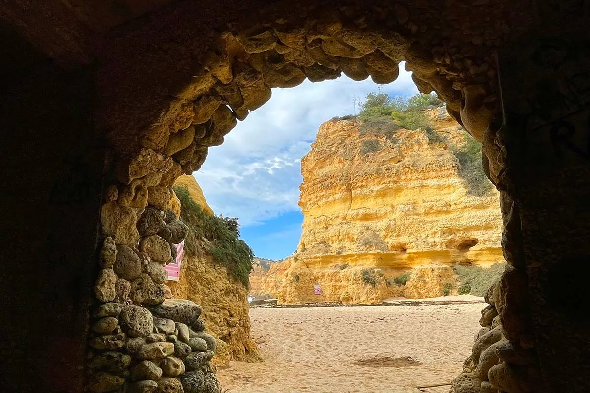 Praia da Marinha beach photographed through the opening of a cave