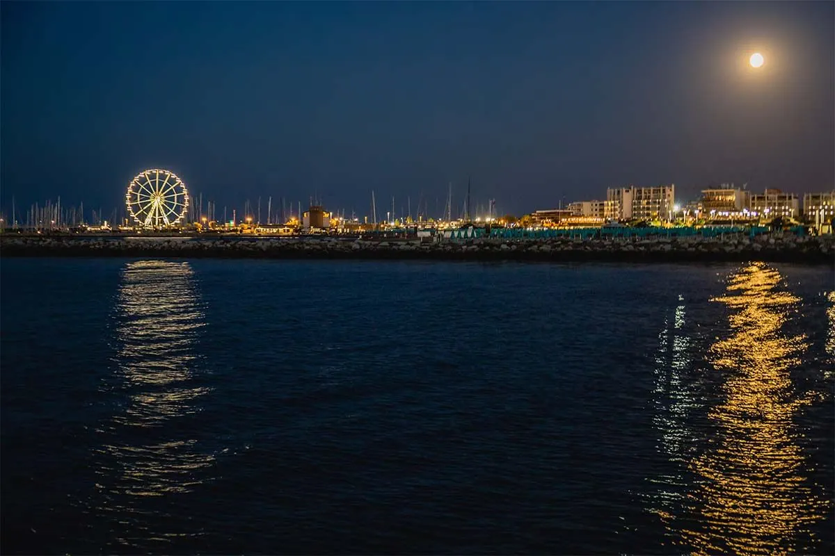 Rimini skyline at night as seen from a sailing boat