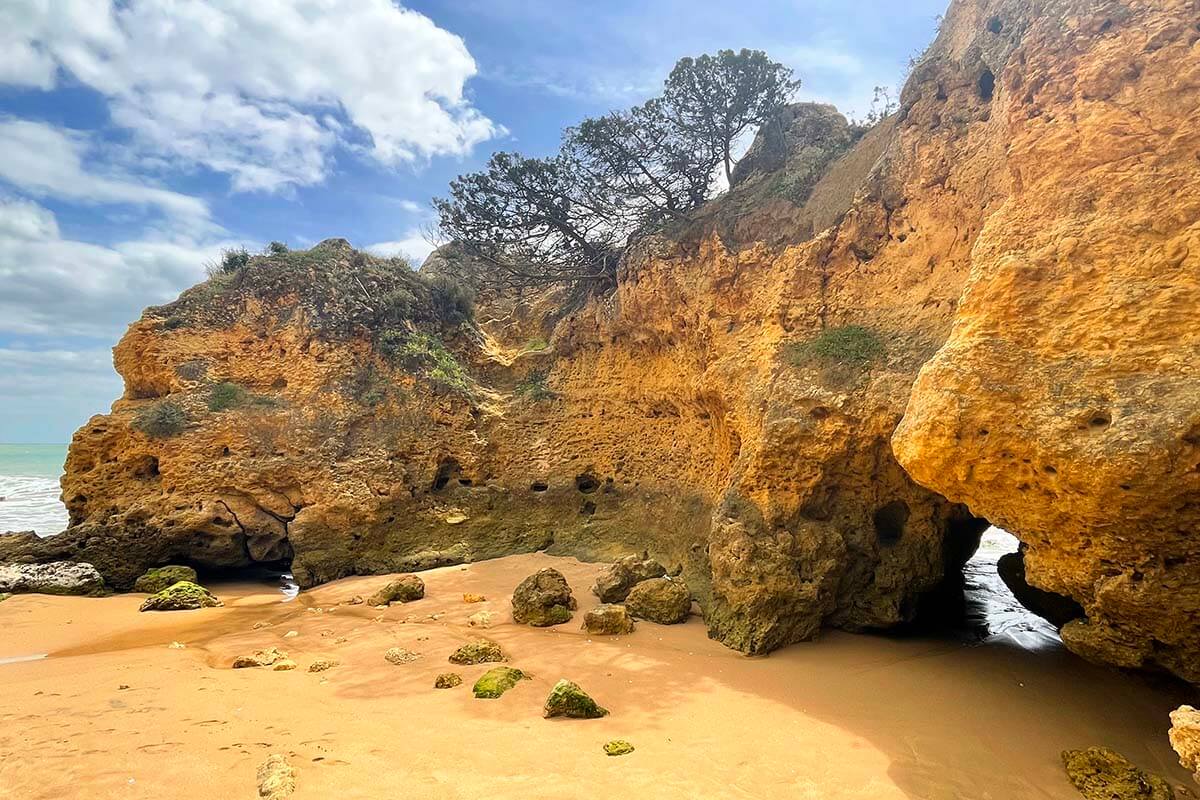 Sandstone cliffs and coves on Praia da Oura beach in Albufeira Portugal
