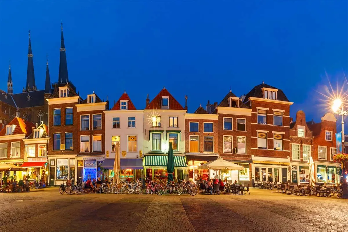 Traditional Dutch buildings on Delft Markt Square in the evening