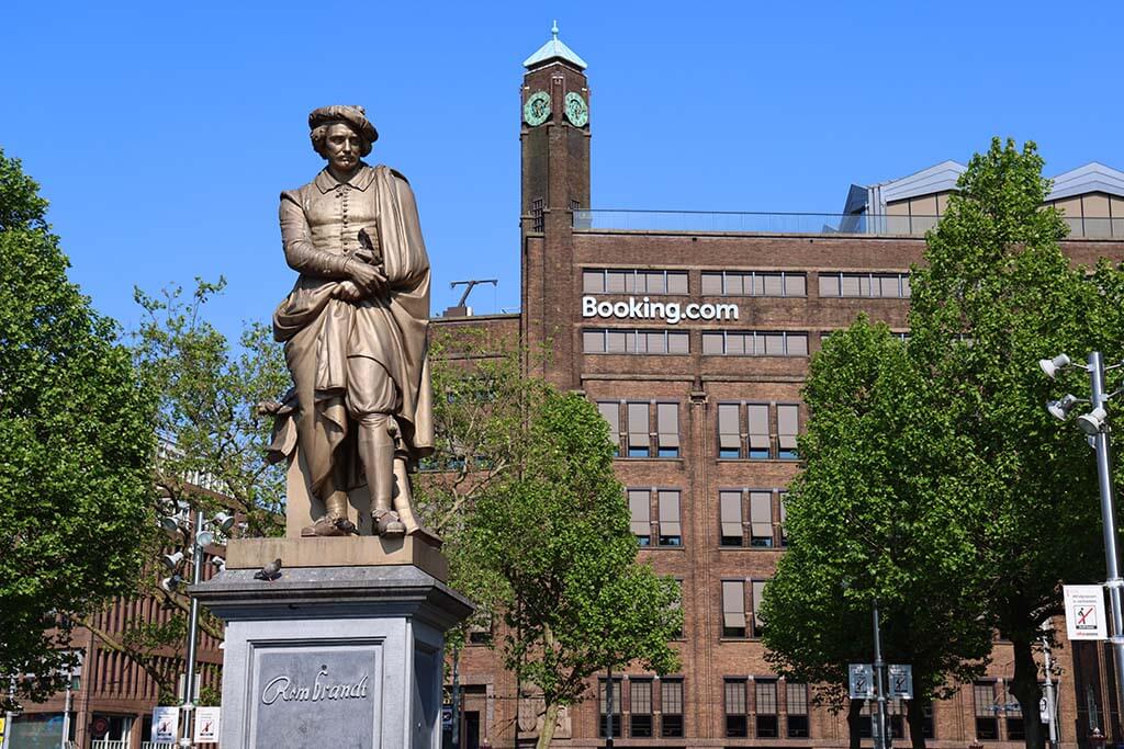 Rembrandt statue and Booking com office building on Rembrandt Square in Amsterdam
