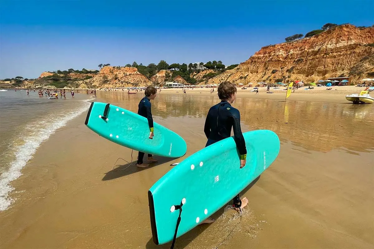 Kids following surf lessons at Falesia Beach in Albufeira