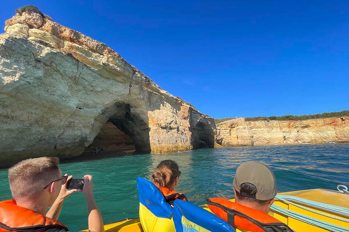 Benagil Cave boat tour - tourists taking pictures of the coastline near Benagil in Portugal