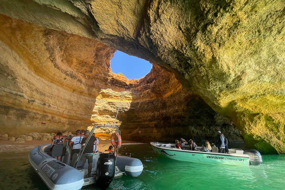 Boats with tourists inside Benagil Cave in Algarve Portugal