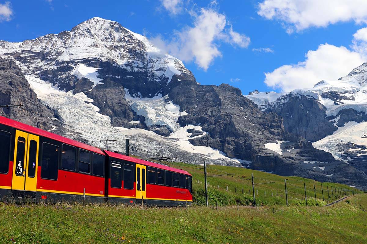 Red train in Swiss mountains in Jungfrau region Switzerland