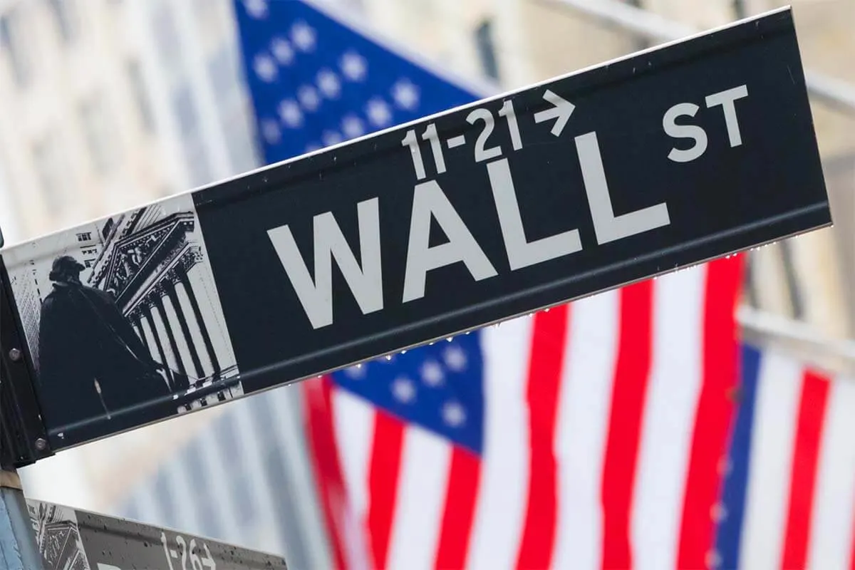 Wall Street sign and USA flags in New York City