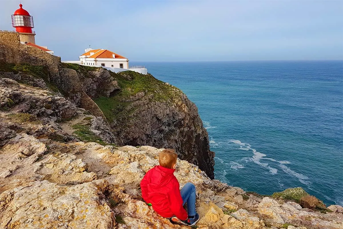 Child at Cape St Vincent Lighthouse in Sagres, Algarve Portugal