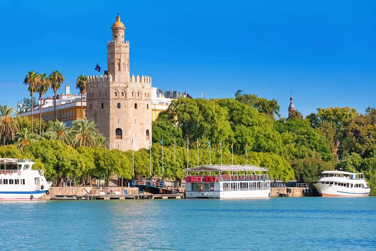 Golden Tower and Guadalquivir River sightseeing boats in Seville Spain