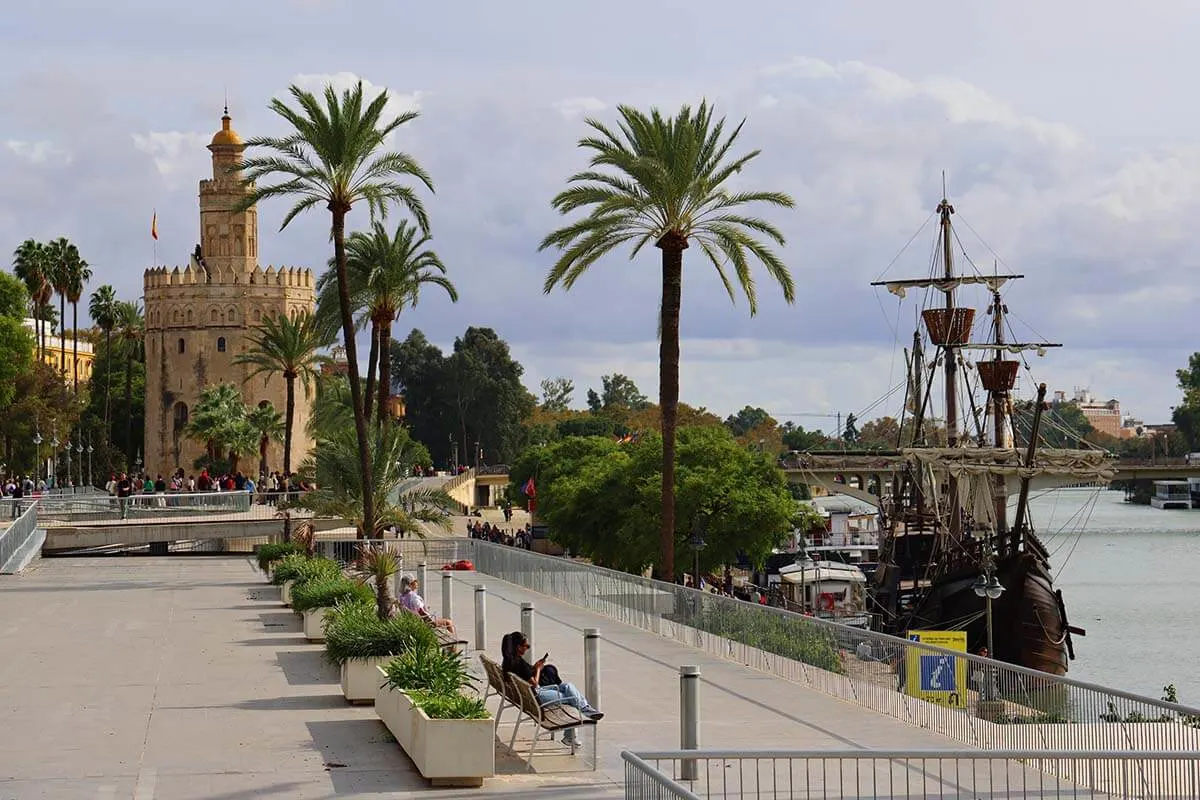 Seville riverside with Torre del Oro and Nao Victoria 500 ship