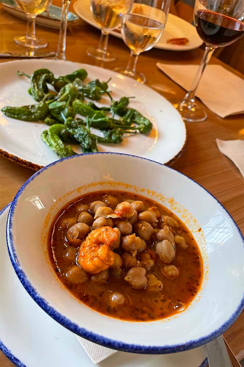 Traditional Sevilla tapas chickpeas and green peppers at a restaurant in Seville Spain