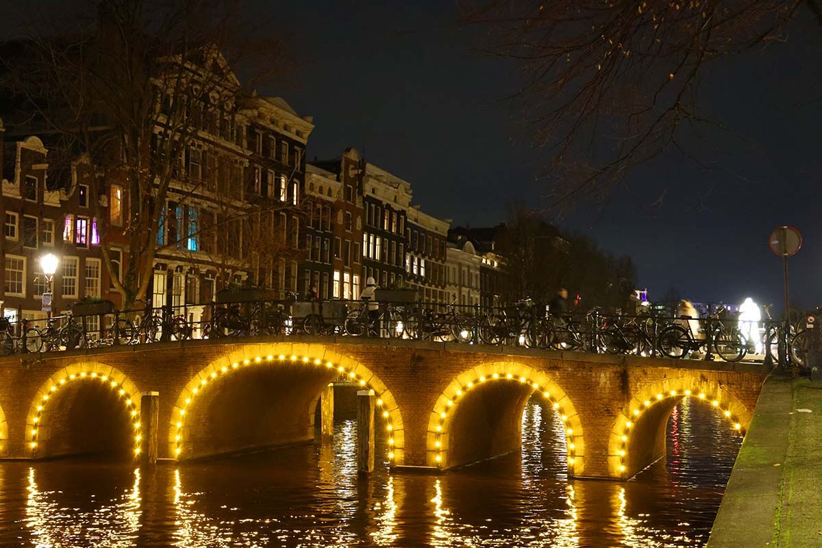 Amsterdam canal bridge lit in the evening during Amsterdam Light Festival