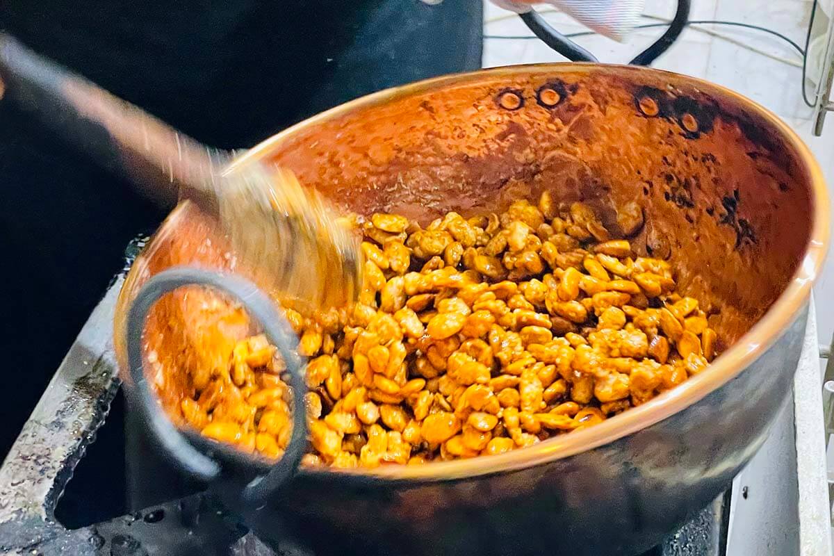 Caramelized pistachios being cooked at a sweets shop in Seville Spain