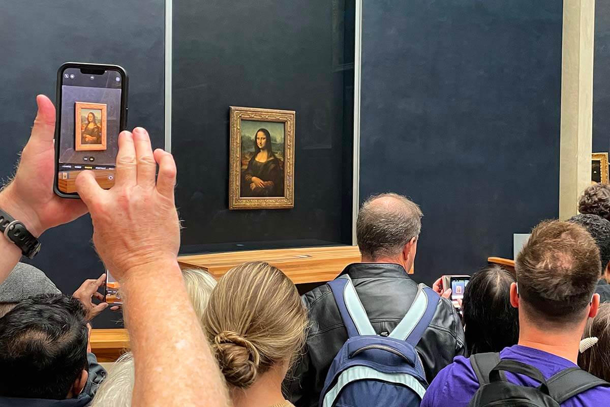 Crowds at the Mona Lisa painting at the Louvre Museum in Paris