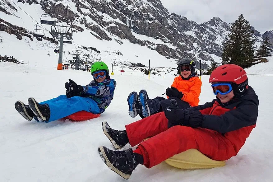 Kids on sleds - winter fun in the Swiss mountains
