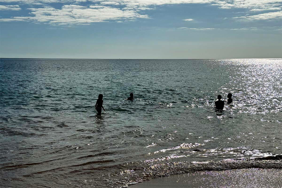 People swimming in the ocean in Albufeira in December