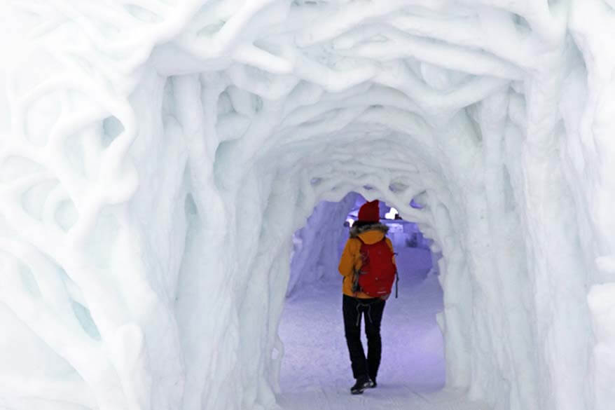 Woman wearing winter clothes at an ice hotel in Norway in winter