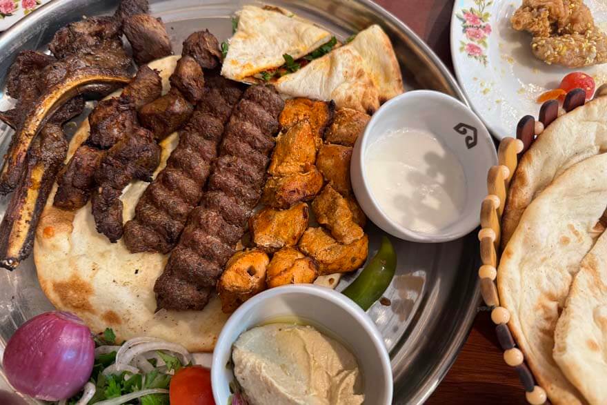 Mixed grill dish and Arabic bread at a restaurant in the UAE - Dubai prices