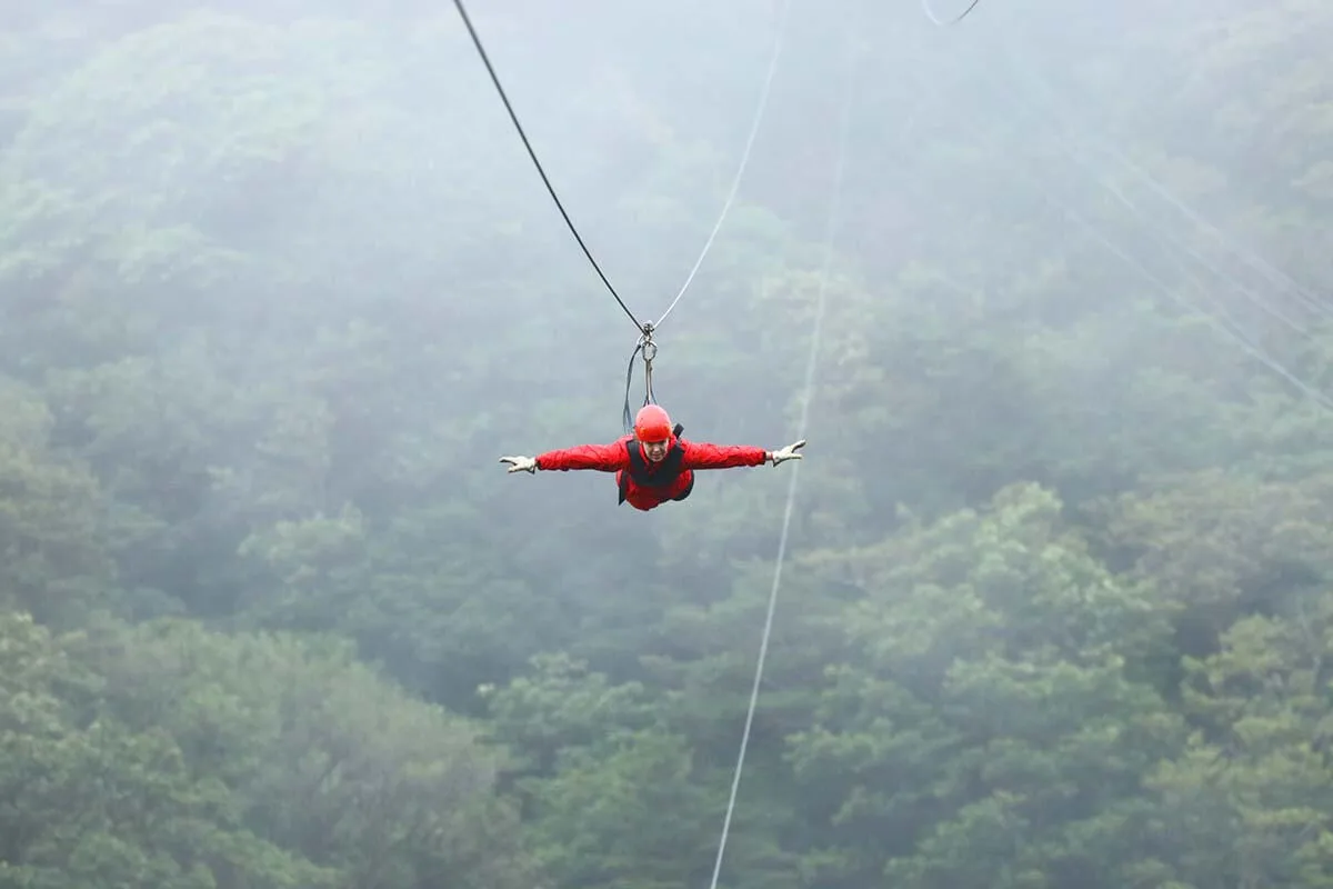 Zip lining Superman ride in Monteverde cloud forest Costa Rica