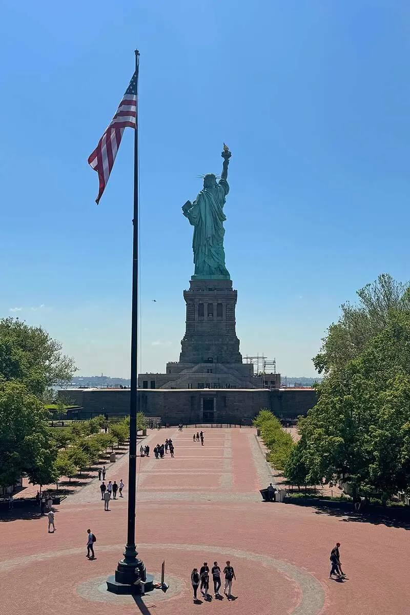 Statue of Liberty and USA flag on Liberty Island