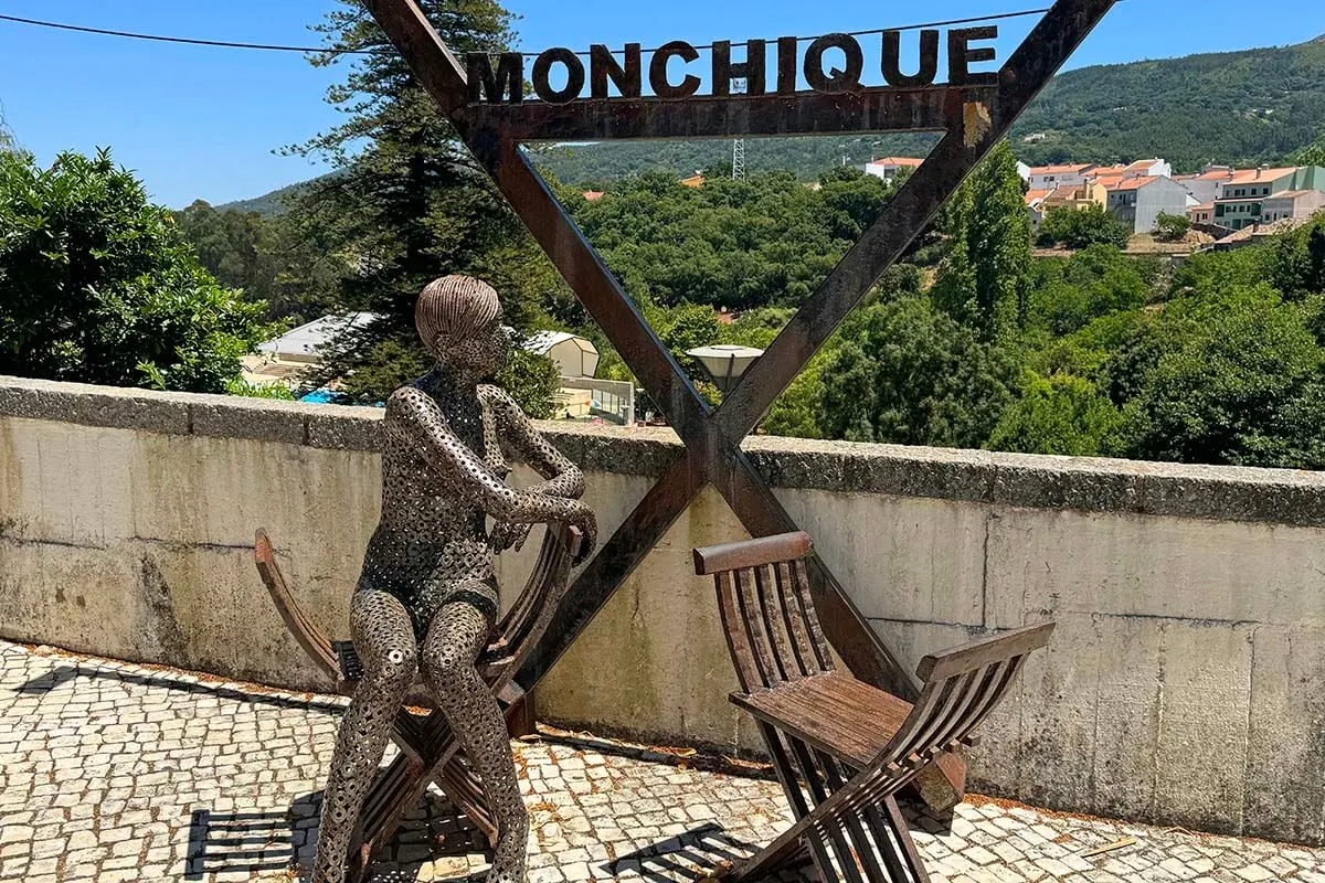 Monchique town sign with a sculpture and typical chairs