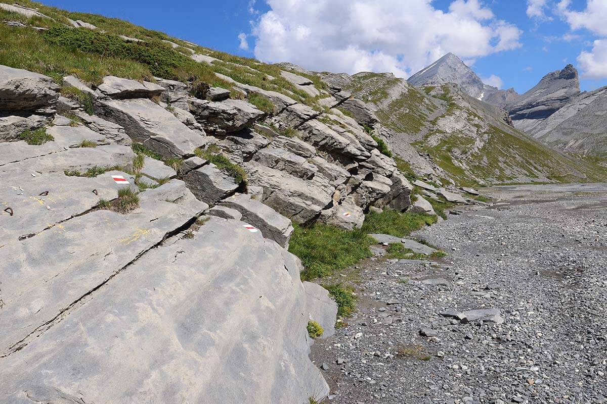 Lammerenhut hiking trail next to a glacial river at Gemmi Pass