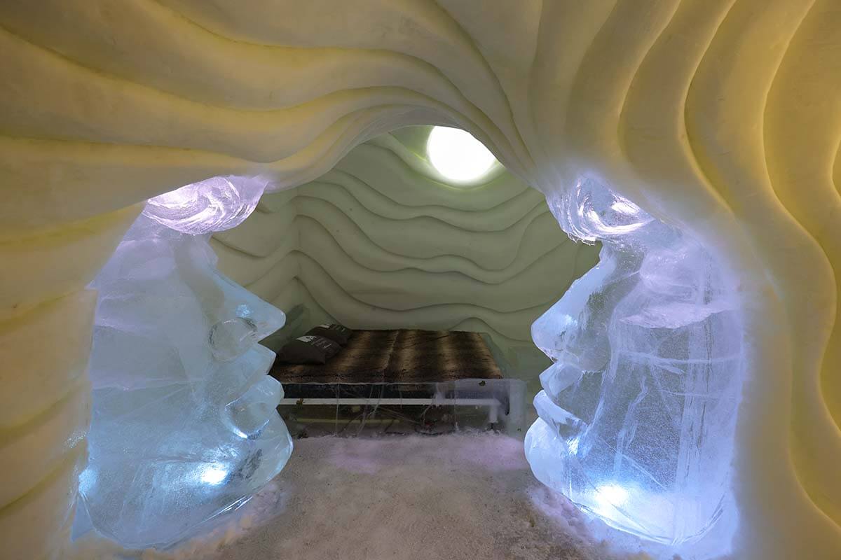 Bedroom inside an ice hotel at Arctic SnowHotel & Glass Igloos in Rovaniemi Finland