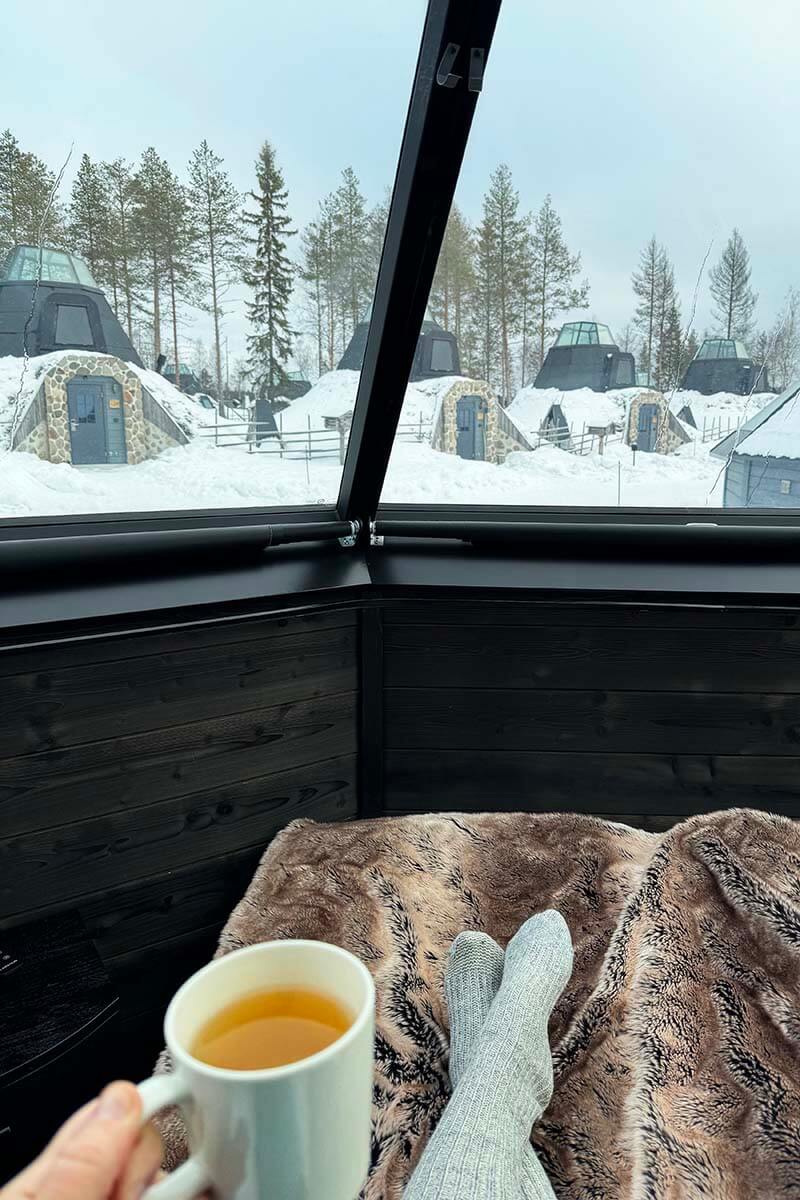 Drinking a cup of tea inside a glass igloo in Rovaniemi Lapland