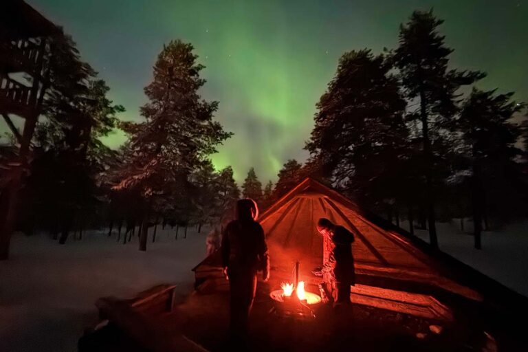 Northern Lights and bonfire at Ounasvaara Observation Tower in Rovaniemi Finland